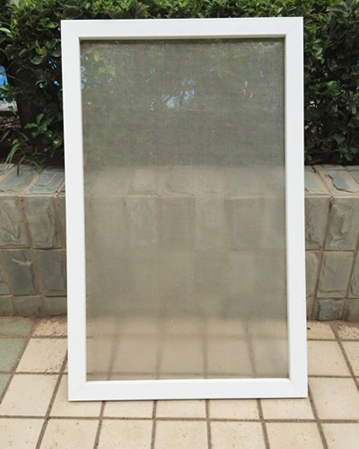 The screen that has been cleaned is being leaned under the sunlight, for getting dry.