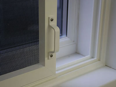 The picture shows a sliding fly screen whose bottom is installed on the guide rail.